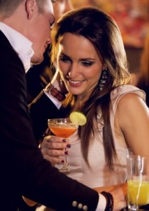 couple in a bar laugh as the man whispers something in the woman’s ear 213x300 Sexy Things You Do Without Even Realizing It